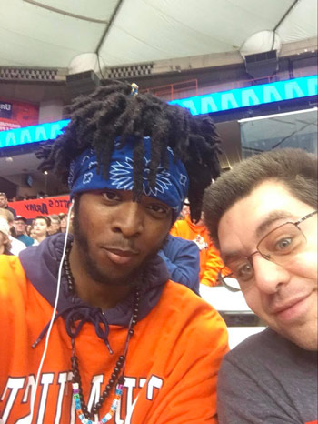 Inclusive U students cleo and jonathan pose at a syracuse basketball game